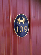 Any color Carved House number with gold crab on black background front view