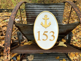 oval house number sign painted white and gold
