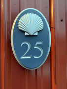 Custom carved house number sign with 25 painted in a custom blue and silver with a gloss finish
