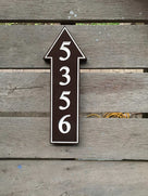 arrow pointing straight ahead painted brown and white