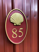 Custom Carved oval house number painted red and gold with number 85 and realistic scallop shell