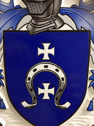Close up of horseshoe carved on family crest plaque