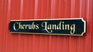 Black and gold quarterboard sign mounted on barn