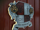 Custom carved and painted Humbert family crest side view
