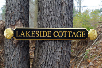 Lakeside Cottage quarterboard with decorative scallop ends painted black and gold