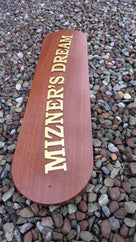Side view of mahogany quarterboard with Mizner's Dream carved on it