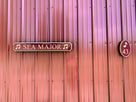 Quaterboard sign with Sea Major carved on it with musical notes and matching house number sign