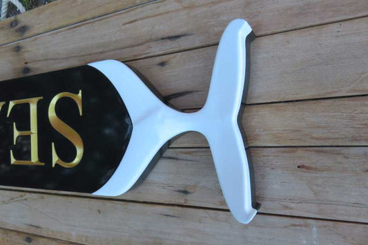 Carved whale tail end on end of quarterboard