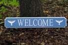 custom quarterboard with Welcome and whale tails carved on it painted light blue and white