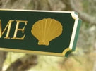 Close up of scallop shell carve on quarterboard sign