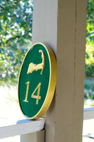 Any color Carved House number with gold cape cod on green background iso view