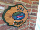 Custom painted cedar sign with camp last name and canoer 