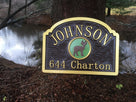 Last name sign with address and deer image in natural setting