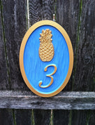 House number sign with bright paint scheme