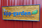 Cedar carved business sign with business logo carved and painted on it