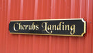 Cherubs Landing wording carved on quarterboard