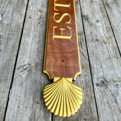 Mahogany quarterboard with gold shells on ends