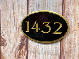 1432 black and gold oval house number sign