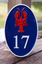 Oval house number painted in three colors with lobster