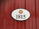 Cusstom carved horizontal oval house number sign with paw print and number 1815