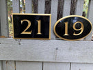 Oval and rectangle shaped house number signs that were custom made