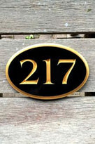 Oval house number sign - black and gold - front view