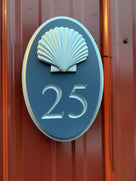 Custom carved house number sign with 25 painted in a custom blue and silver with a gloss finish