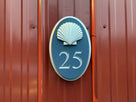 Oval house number 25 painted in a custom blue and silver with a gloss finish