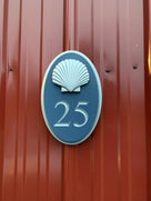 Custom carved house number sign painted blue and silver with 25
