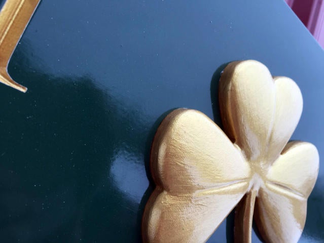 Close up of shamrock on quarterboard sign