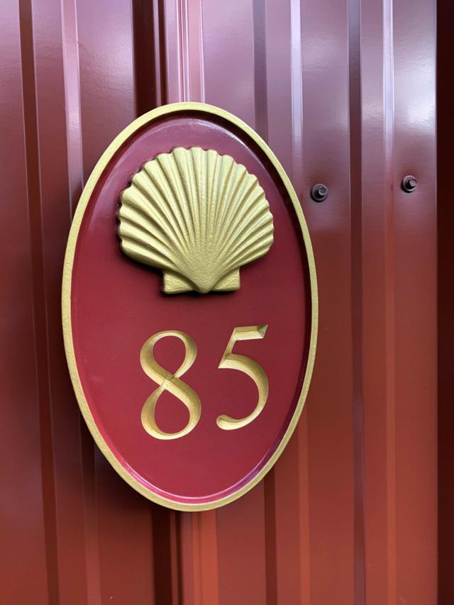 Custom Carved oval house number painted red and gold with number 85 and realistic scallop shell