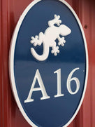 Any color Carved House number with white gecko on blue background close up