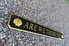 Custom engraved sign painted black and gold with 3D scallop shells on ends