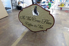 Ornate shaped coffee shop sign with business name and crow carved and painted on it called As the Crow Flies