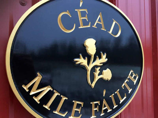Custom Carved Gaelic Welcome Last name sign with Thistle (LN62) - The Carving Company close up iso view