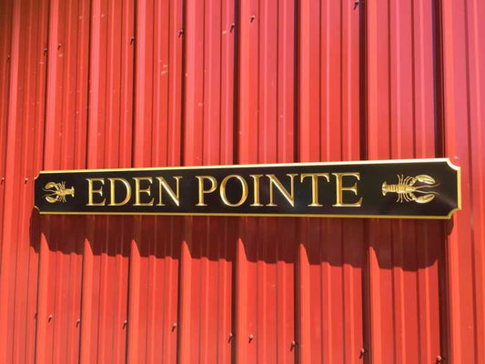 Custom carved quarterboard with Eden Pointe and lobster carved on it