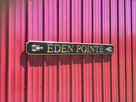 Custom carved quarterboard with Eden Pointe and lobster carved on it painted black and gold