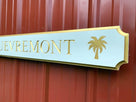 Close of of palm tree carved on quarterboard sign