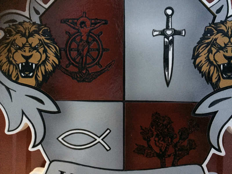 Custom carved and painted Humbert family crest with lion heads