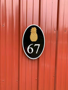 Custom house number sign with pineapple emblem and three colors
