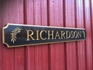 Custom quarterboard with Richardson and olive branch carved on it and painted black and gold