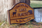 Angle view of cedar carved camp sign with buck and bear