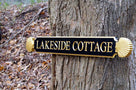 Quarterboard with Lakeside Cottage wording and decorative scallop ends painted black and gold