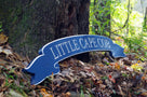 Side view of banner style quarterboard painted blue and silver saying Little Cape Cob