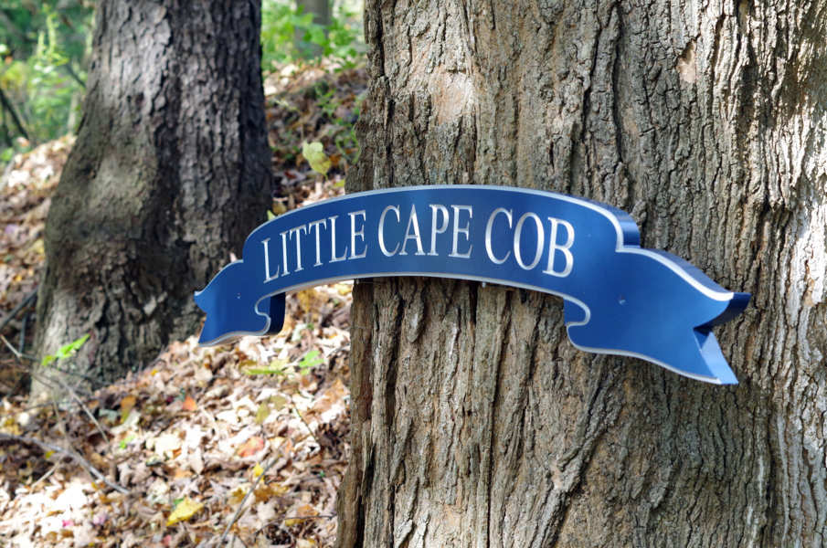 Side view of banner style quaterboard with Little Cape Cob carved on in