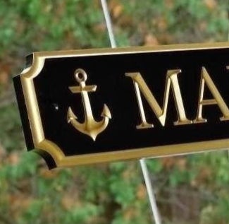 Close up of achorl carve on quarterboard sign