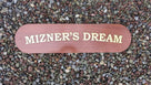 Mahogany quarterboard with Mizner's Dream carved on it in gold
