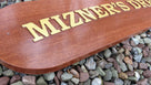 Close up view of mahogany quarterboard with Mizner's Dream carved on it