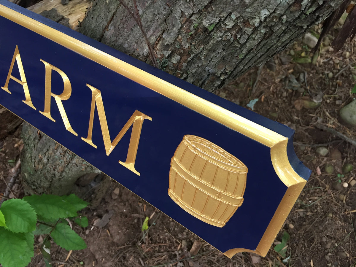 Close up of rain barrels painted navy blue and gold