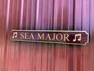 Quaterboard sign with Sea Major carved on it with musical notes